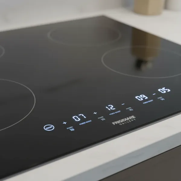 A close-up of the Frigidaire Gallery 30-inch induction cooktop's touch control panel, showing numbers and power settings.