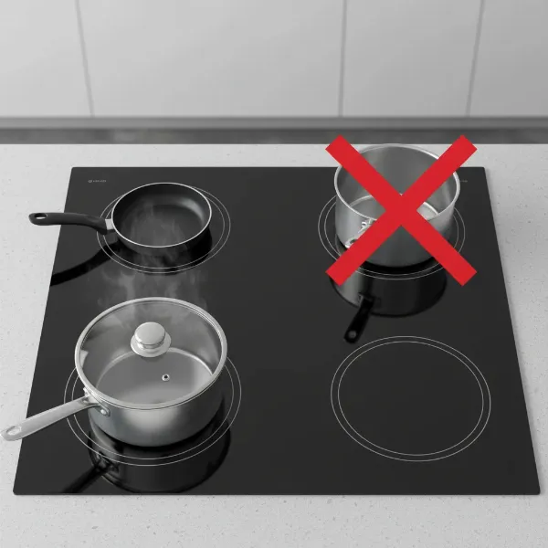 An induction cooktop illustrating correct and incorrect pan placement and size, highlighting how to avoid "pan not detected" errors.